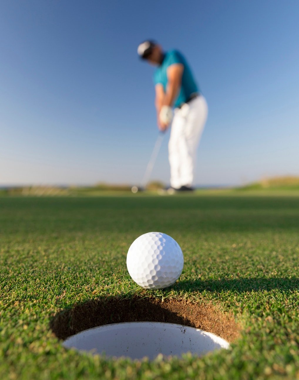 Person Putting Golf Ball